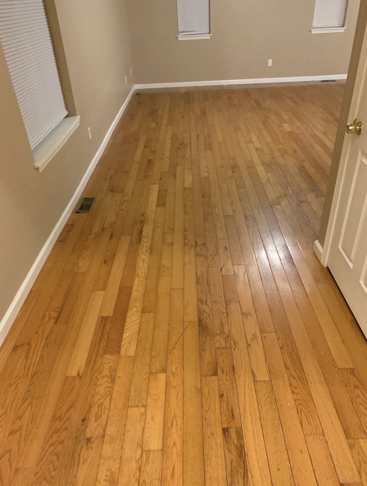 Hardwood floor after QCC post-construction cleaning — clean and shining